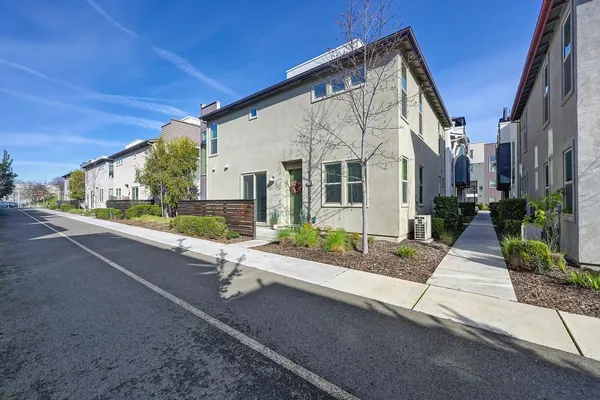 a kitchen with stainless steel appliances a stove top oven a chimney and a refrigerator