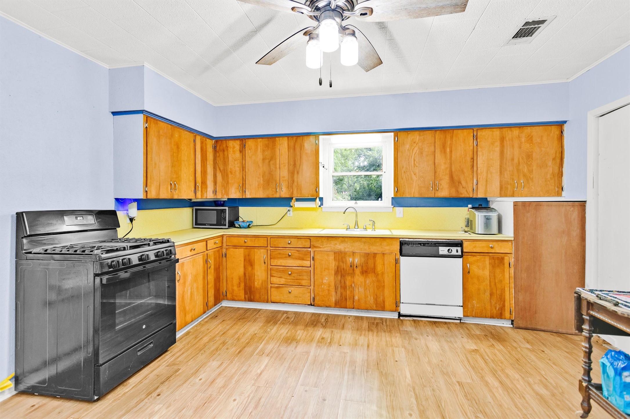 1720 18th Street Huntsville, TX 77340 - Photo 14 of 37 a kitchen with stainless steel appliances granite countertop a sink and a stove