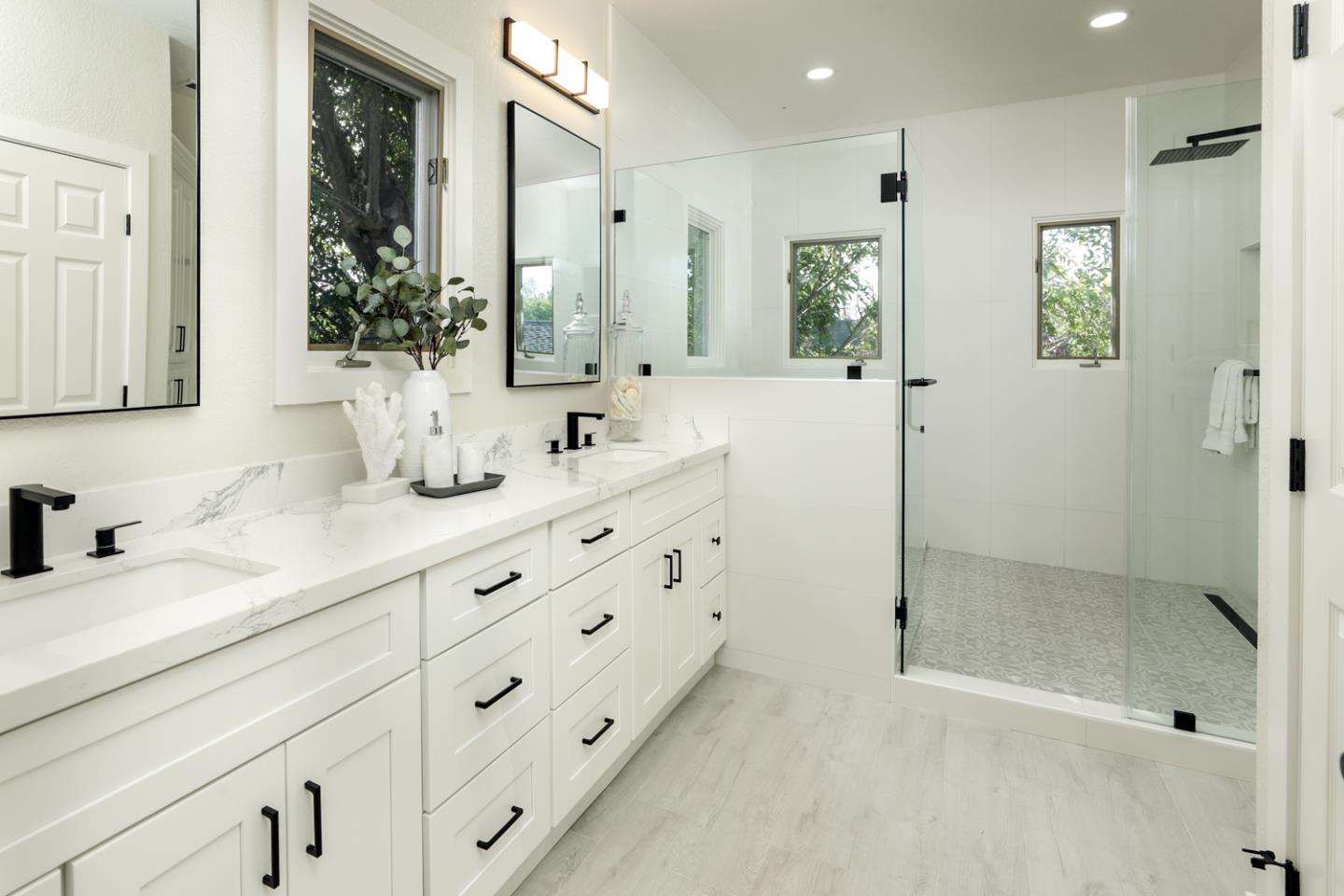 694 Morse Street San Jose, CA 95126 - Photo 18 of 38 a bathroom with double vanity sinks and a mirror