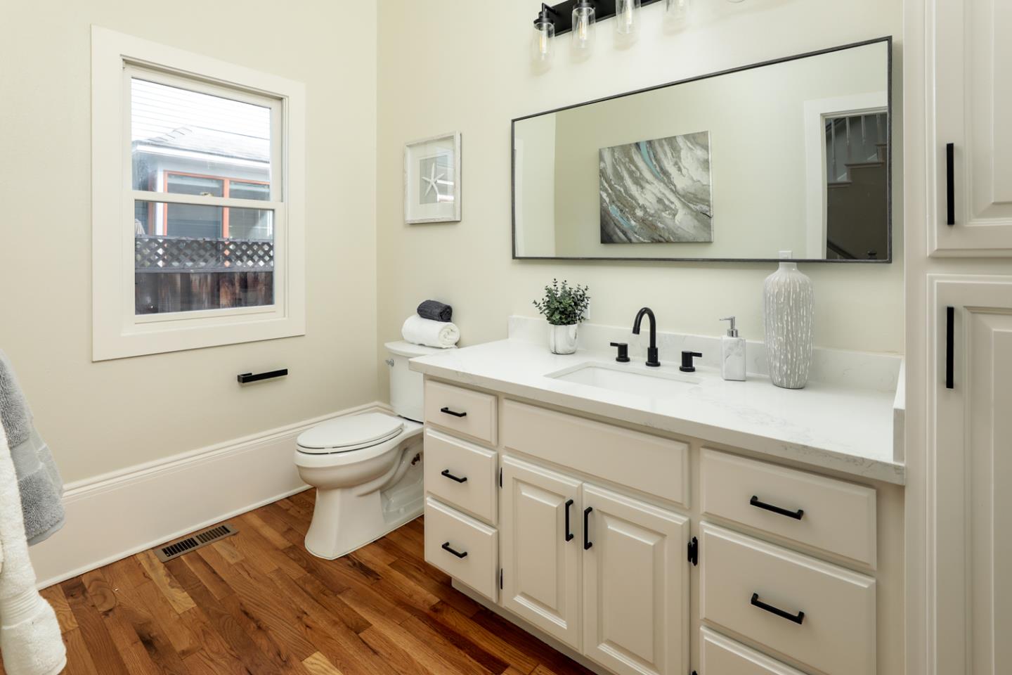 694 Morse Street San Jose, CA 95126 - Photo 30 of 38 a bathroom with a toilet sink and mirror