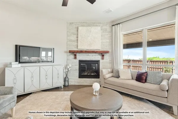 a living room with furniture a flat screen tv and a fireplace