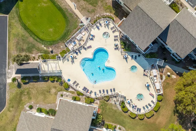 an aerial view of a house with a swimming pool