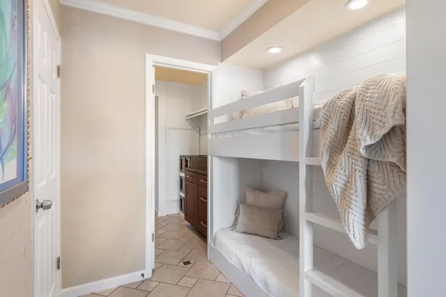 a living room with a couch and a walk in closet with wooden floor