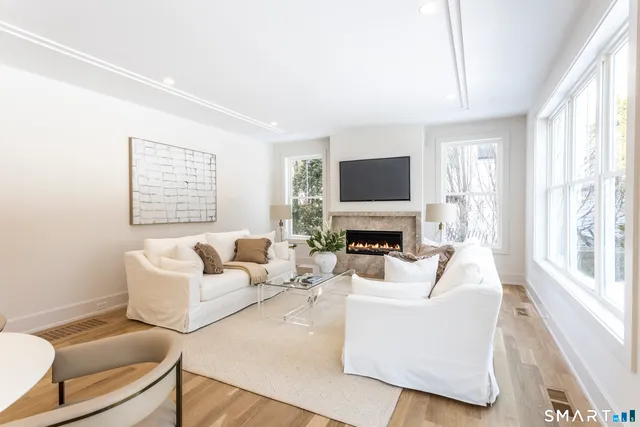 a view of a hallway with couch and cabinet