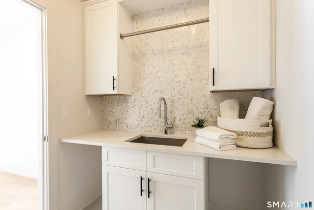 a spacious bedroom with a bed a mirror and a window