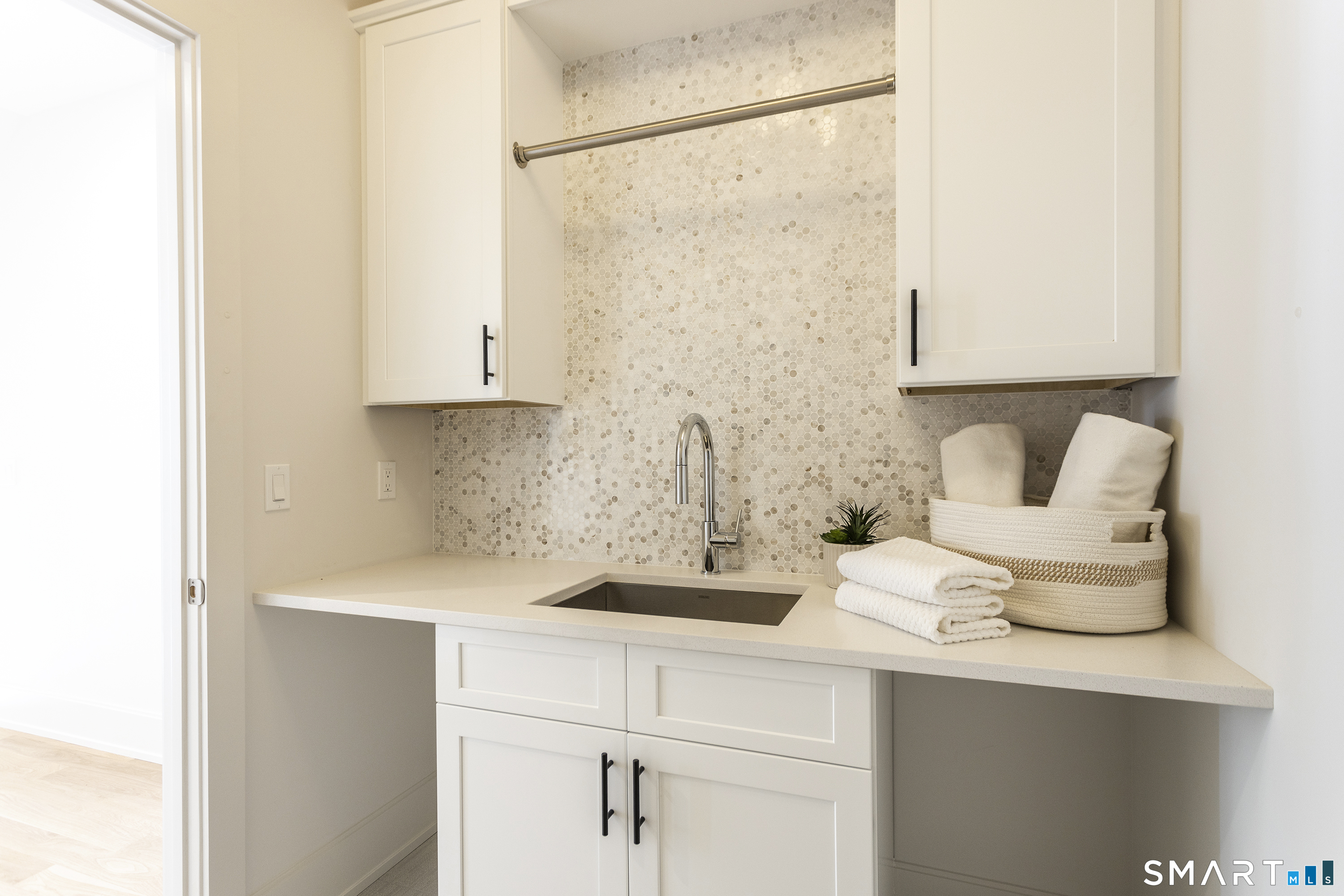 10 Wakenor Road Westport, CT 06880 - Photo 14 of 34 Centrally located laundry room on second floor with tiled backsplash and cabinets