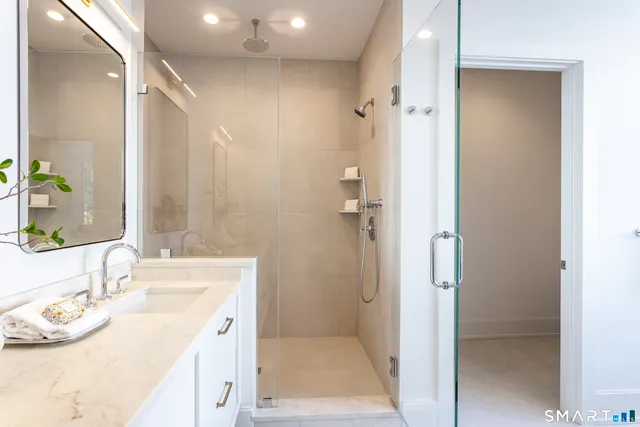 a white bath tub sitting in a bathroom next to a window