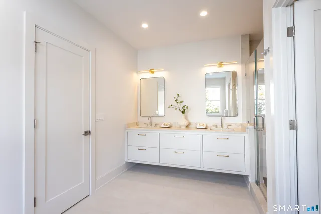 a bathroom with a double vanity sink and a mirror