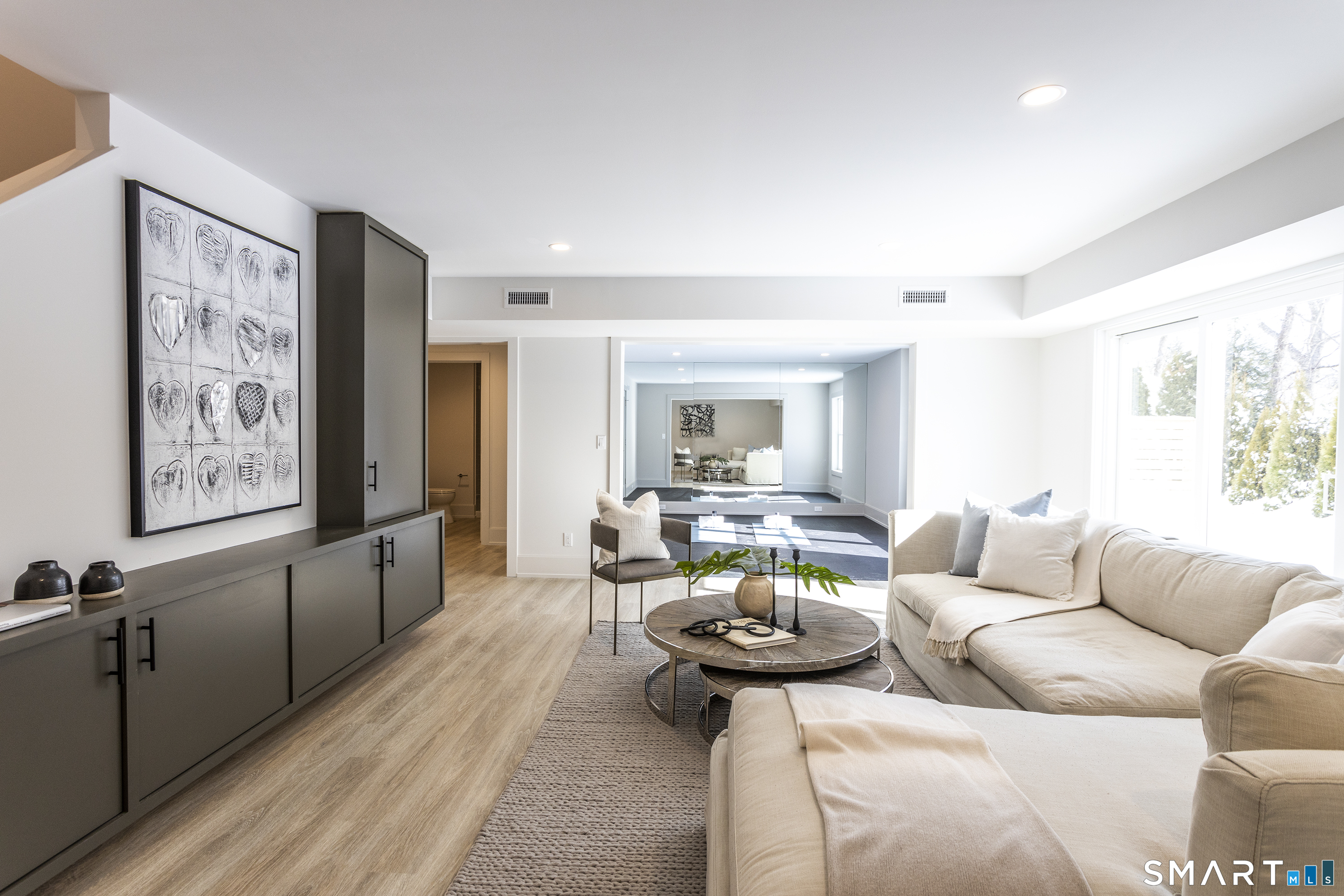 10 Wakenor Road Westport, CT 06880 - Photo 27 of 34 Gotta love a finished lower level with tons of light! Custom built-ins & sliding door walk-out to ground level.