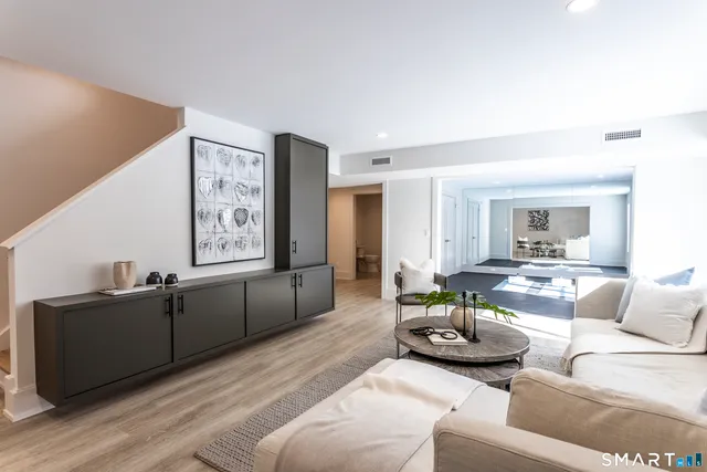 a view of a livingroom with wooden floor and a window
