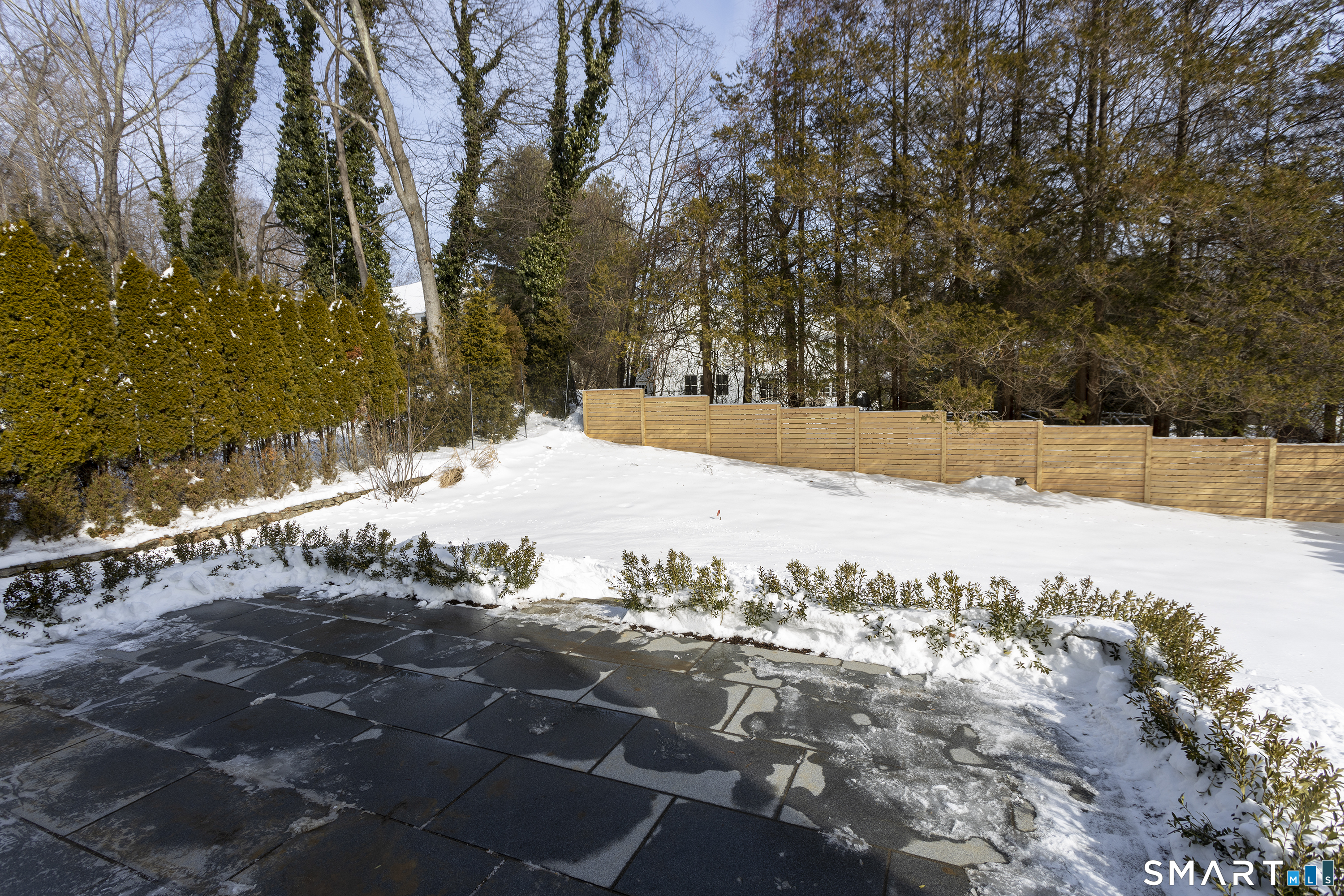 10 Wakenor Road Westport, CT 06880 - Photo 34 of 34 Granite patio, steps down to spacious backyard. Room for pool. Beautiful landscaping & fence to ensure privacy.