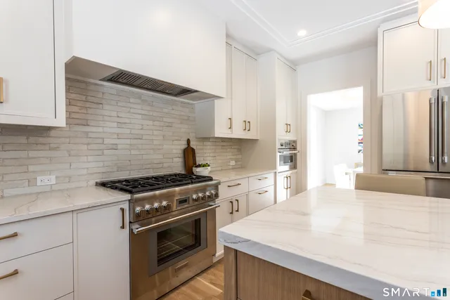 a kitchen with a sink stove and refrigerator