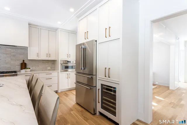 a kitchen with kitchen island a dining table and chairs