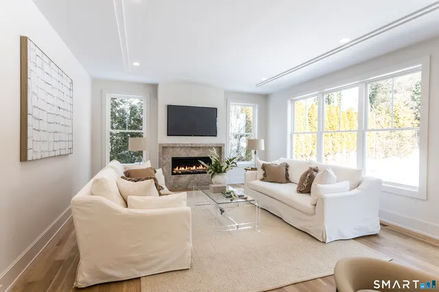a living room with fireplace furniture and a flat screen tv