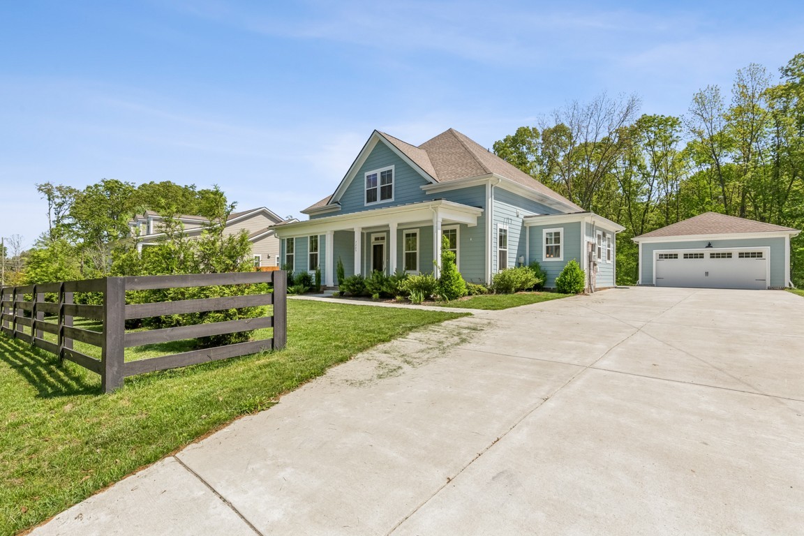 7205 Lake Road Northwest Fairview, TN 37062 - Photo 1 of 28 a front view of a house with a garden and plants