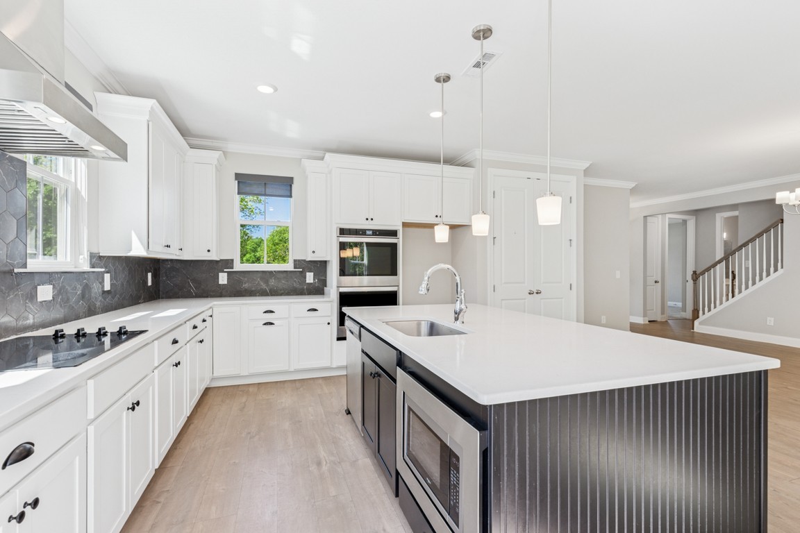 7205 Lake Road Northwest Fairview, TN 37062 - Photo 7 of 28 a kitchen with a sink stove and cabinets