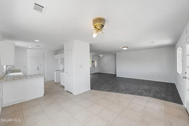 a view of a hallway to closet and a window