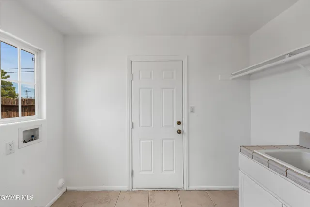 a view of kitchen and white refrigerator