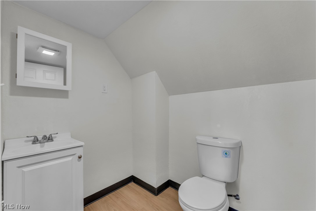 12905 Watterson Avenue Cleveland, OH 44105 - Photo 25 of 30 Half bath with vanity, lofted ceiling, and light wood-style floors
