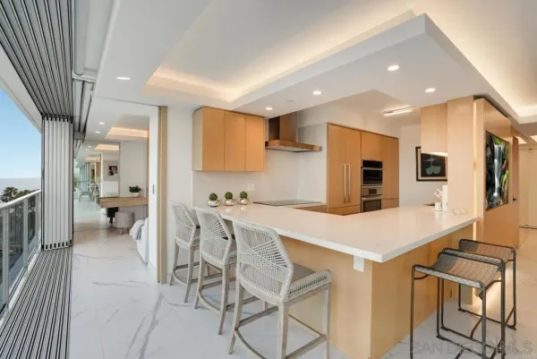 a large kitchen with a table and chairs
