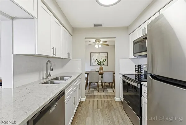 a kitchen with a sink stove and cabinets