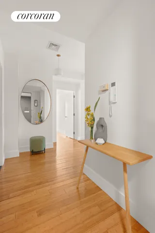 a kitchen with a wooden floor and cabinets