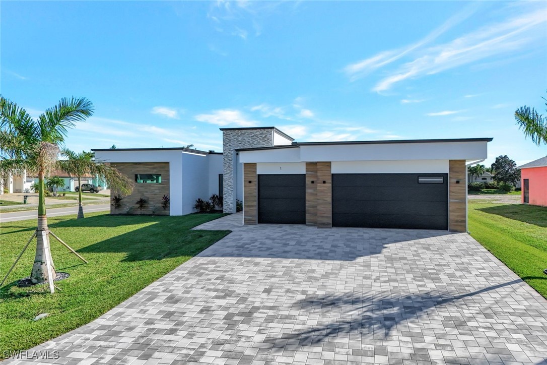 1 Southwest 33rd Place Cape Coral, FL 33991 - Photo 32 of 38 a front view of house with yard and green space