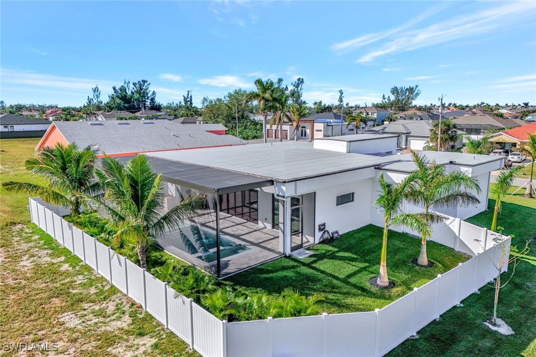 1 Southwest 33rd Place Cape Coral, FL 33991 - Photo 35 of 38 a view of a house with a yard and potted plants