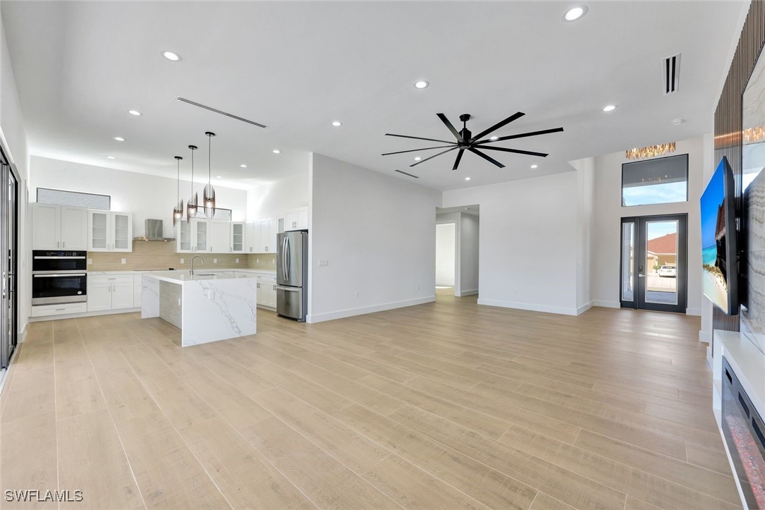 1 Southwest 33rd Place Cape Coral, FL 33991 - Photo 7 of 38 a view of kitchen with furniture and wooden floor