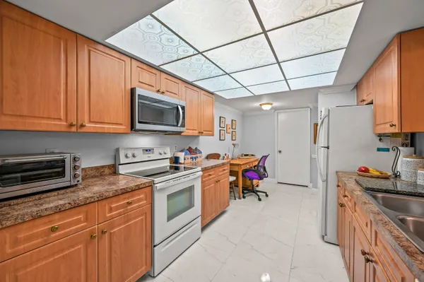 a kitchen with stainless steel appliances granite countertop a stove refrigerator sink and cabinets