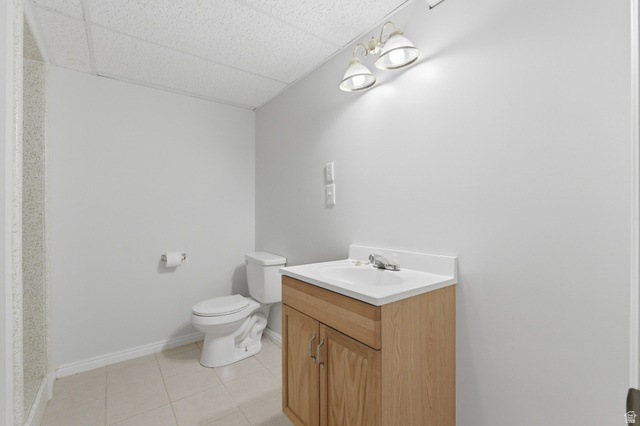 148 Tennyson Avenue Sandy, UT 84070 - Photo 33 of 55 Bathroom featuring a wood-finish vanity with an integrated sink and chrome faucet