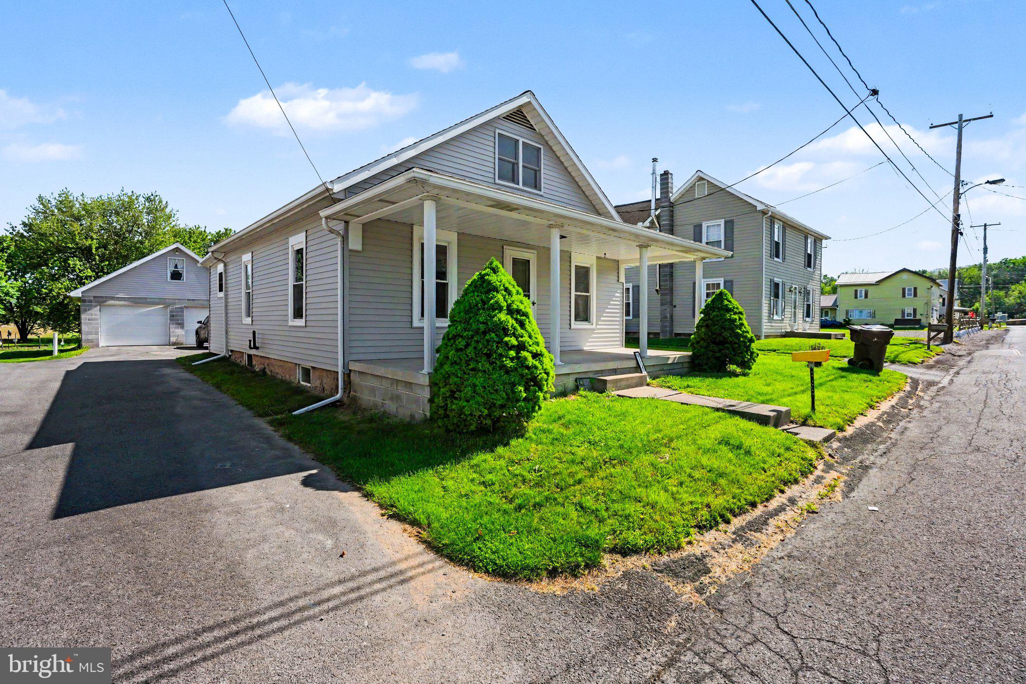 1441 North River Road Granville, PA 17029 - Photo 2 of 28 a front view of a house with a yard and potted plants