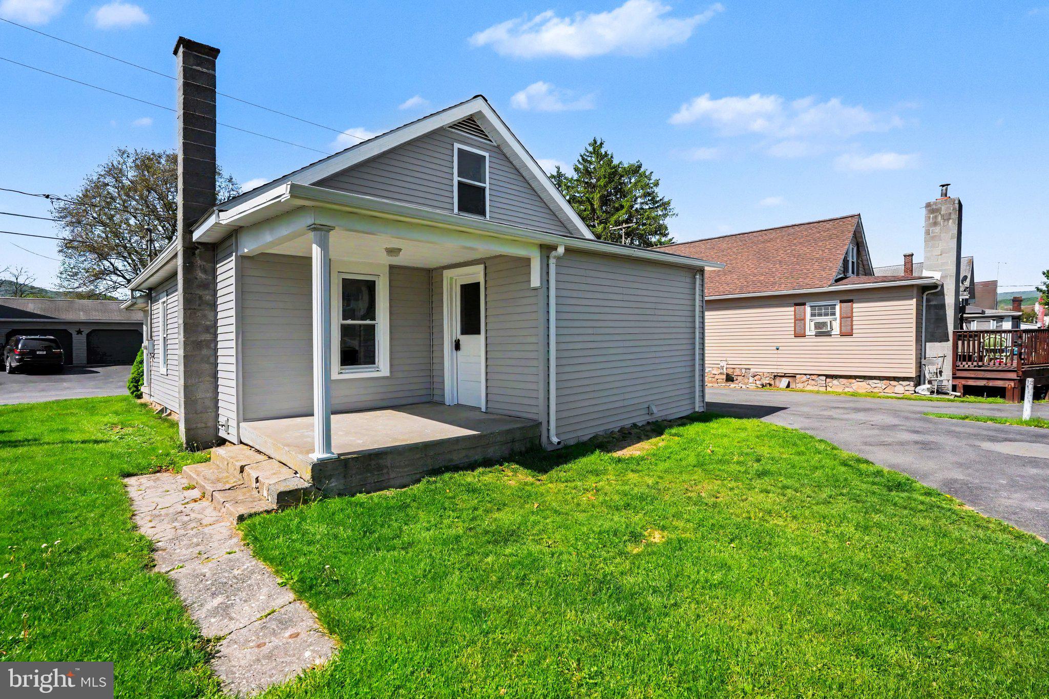 1441 North River Road Granville, PA 17029 - Photo 23 of 28 a front view of a house with a yard and garage