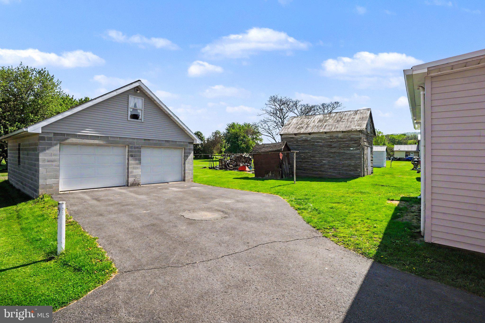 1441 North River Road Granville, PA 17029 - Photo 3 of 28 a front view of a house with a yard and garage