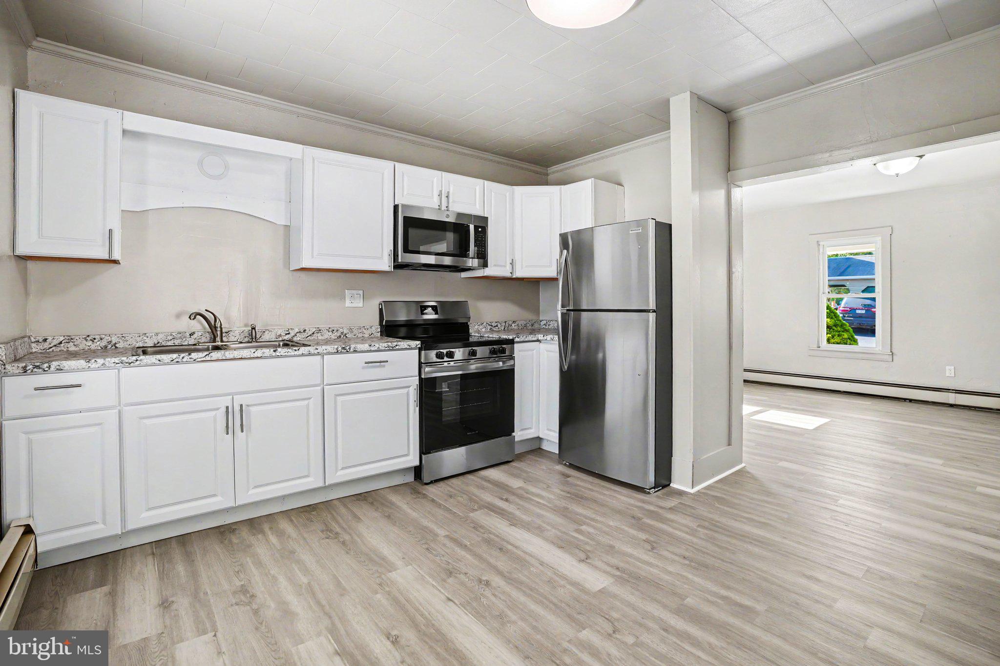 1441 North River Road Granville, PA 17029 - Photo 4 of 28 a kitchen with a refrigerator cabinets and wooden floor