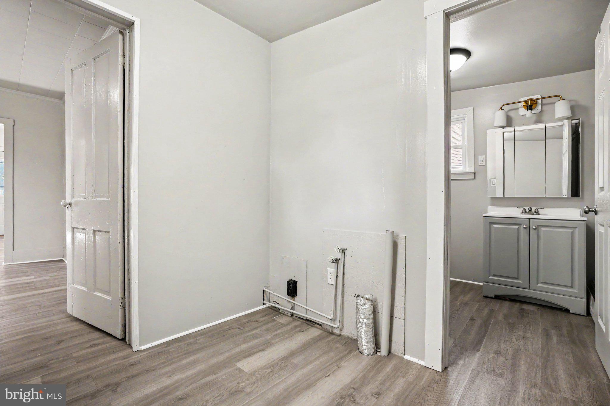 1441 North River Road Granville, PA 17029 - Photo 8 of 28 a view of a hallway with wooden floor and a sink