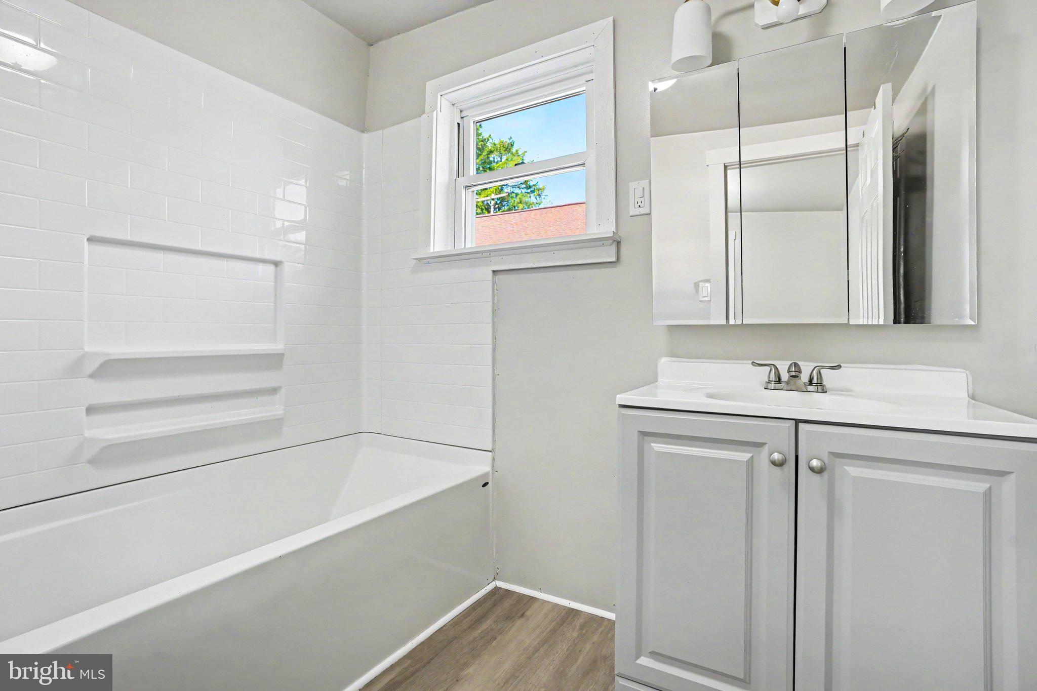 1441 North River Road Granville, PA 17029 - Photo 9 of 28 a bathroom with a sink a mirror and a bathtub