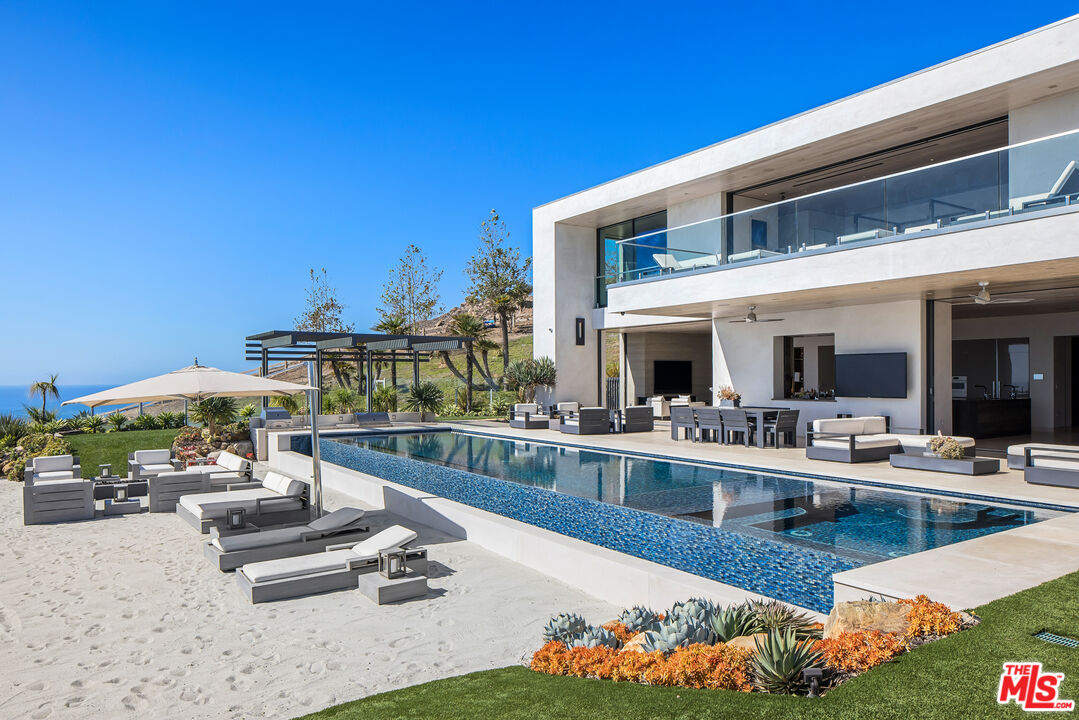 a view of a swimming pool and lounge chairs