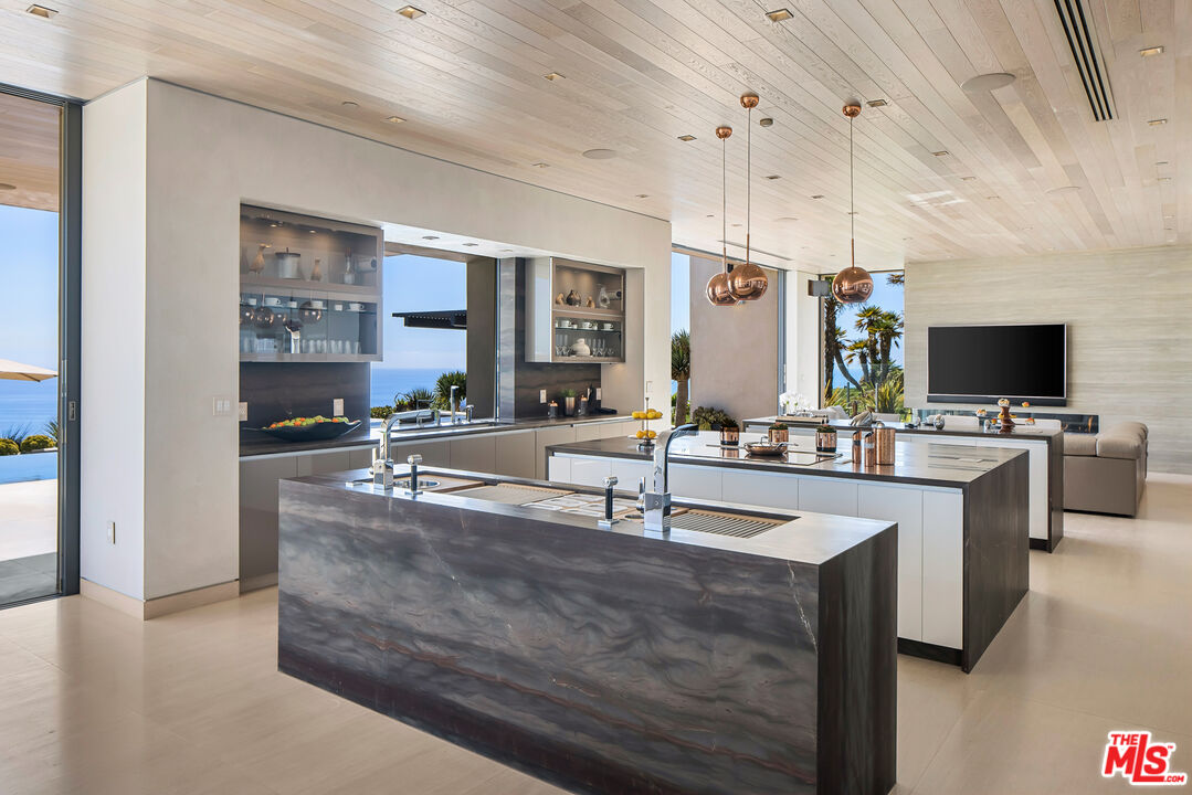 5046 Carbon Beach Terrace Malibu, CA 90265 - Photo 19 of 75 a large kitchen with kitchen island a sink stainless steel appliances and cabinets