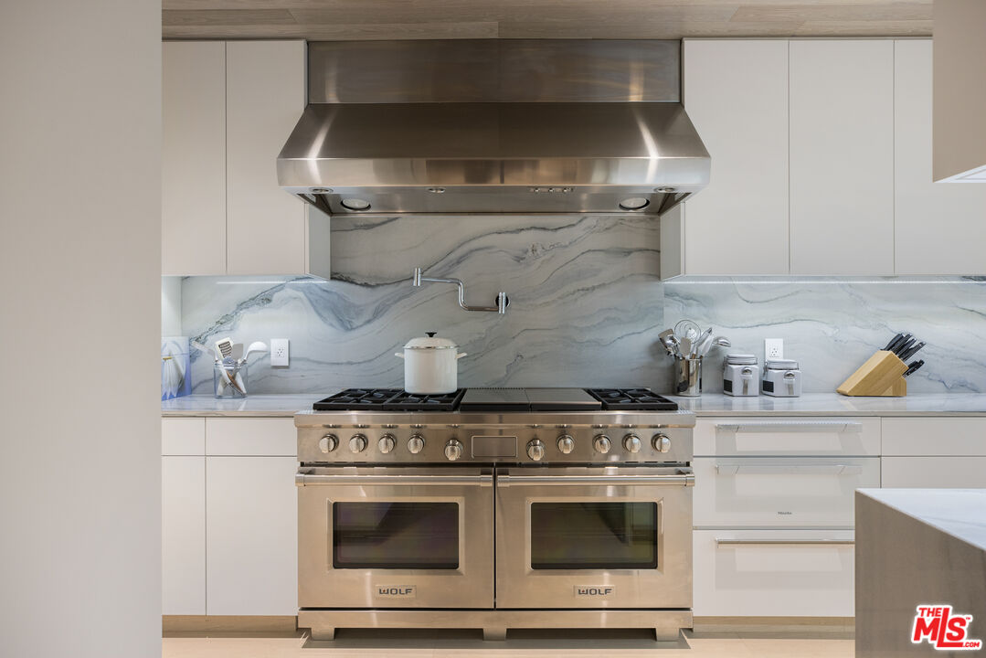 5046 Carbon Beach Terrace Malibu, CA 90265 - Photo 25 of 75 a stove top oven sitting inside of a kitchen