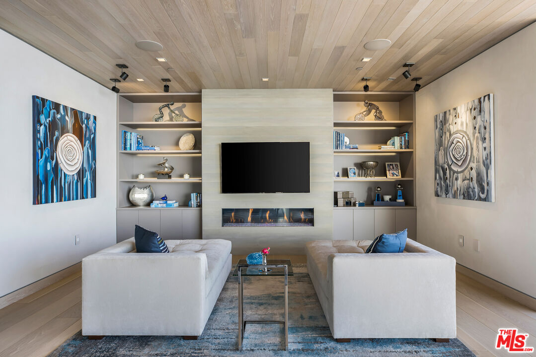 5046 Carbon Beach Terrace Malibu, CA 90265 - Photo 35 of 75 a living room with furniture and a flat screen tv