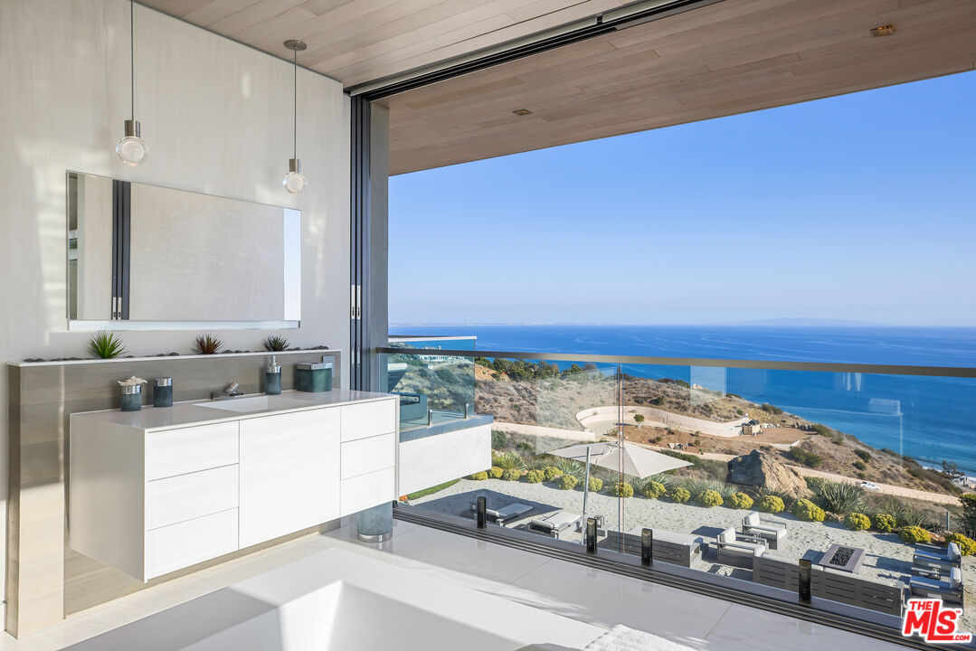 5046 Carbon Beach Terrace Malibu, CA 90265 - Photo 40 of 75 a bathroom with a sink and a mirror