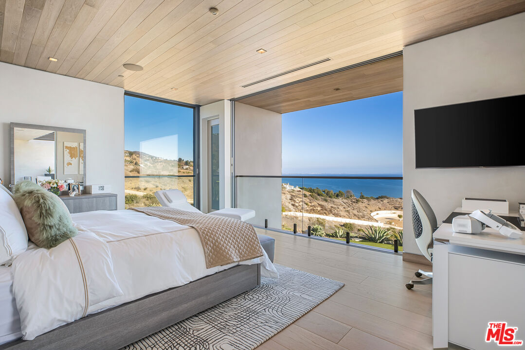 5046 Carbon Beach Terrace Malibu, CA 90265 - Photo 46 of 75 a bedroom with a bed and a flat screen tv