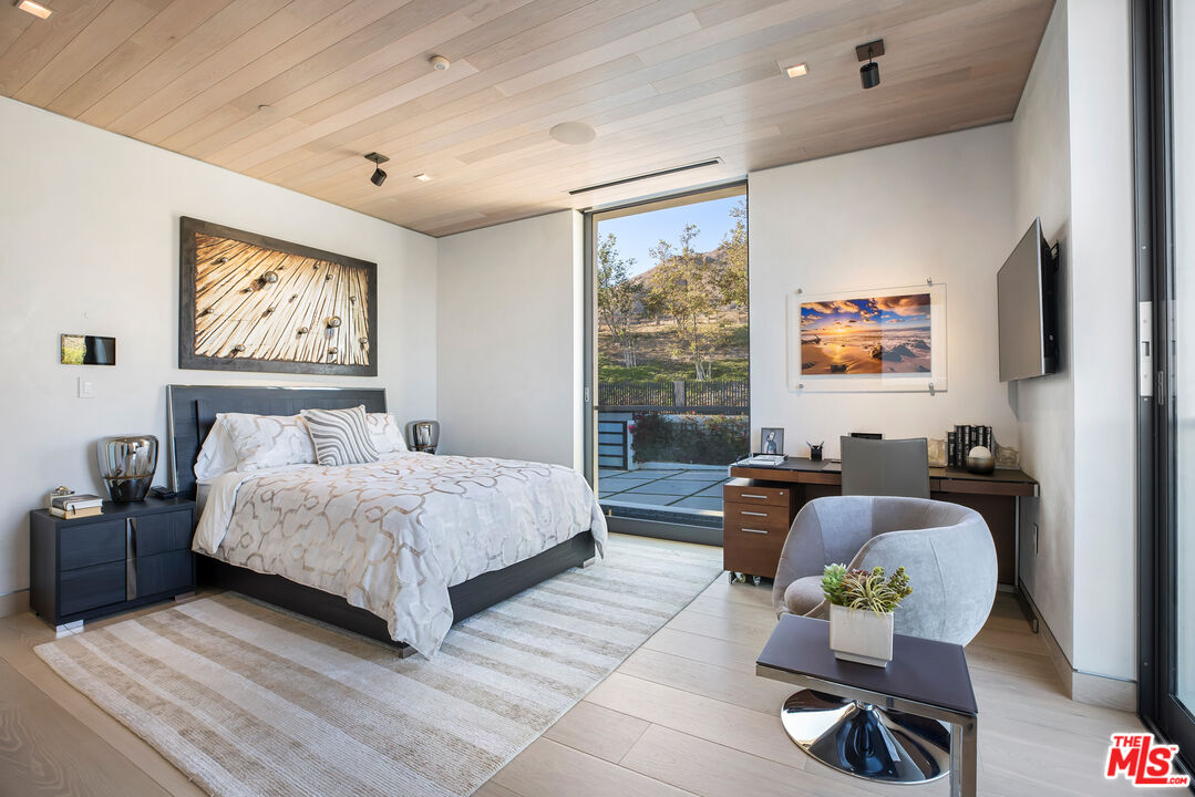 5046 Carbon Beach Terrace Malibu, CA 90265 - Photo 48 of 75 a bedroom with a bed and furniture