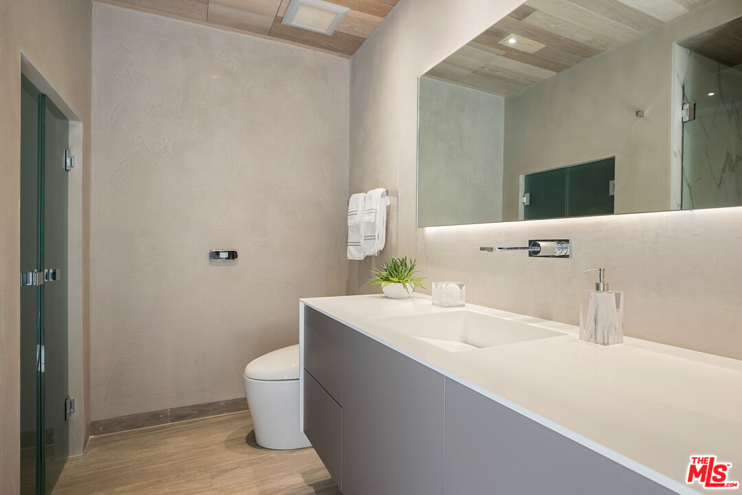 5046 Carbon Beach Terrace Malibu, CA 90265 - Photo 51 of 75 a bathroom with a sink a toilet and mirror