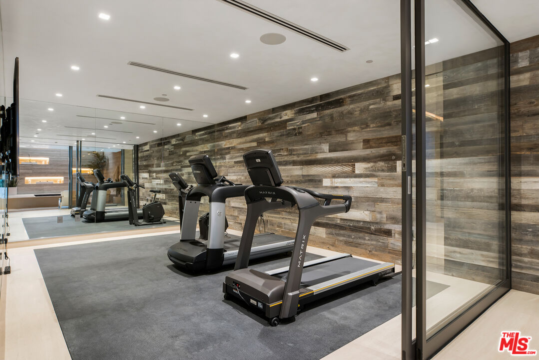 5046 Carbon Beach Terrace Malibu, CA 90265 - Photo 58 of 75 a room with gym equipment and glass door