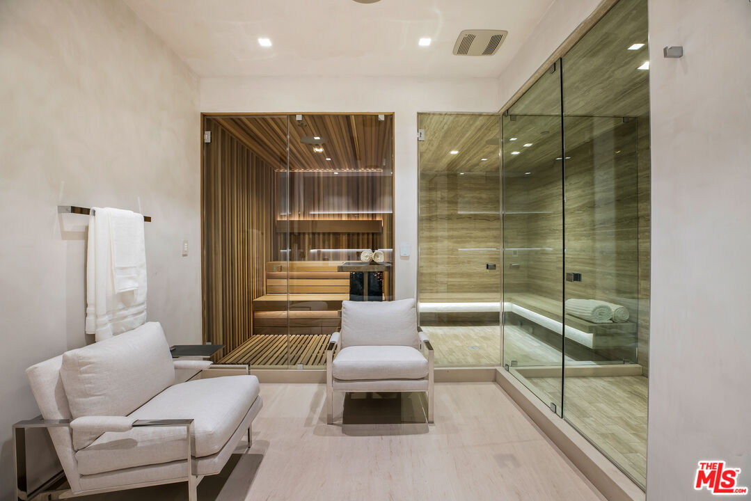 5046 Carbon Beach Terrace Malibu, CA 90265 - Photo 61 of 75 a bathroom with a walk in closet and a glass door shower