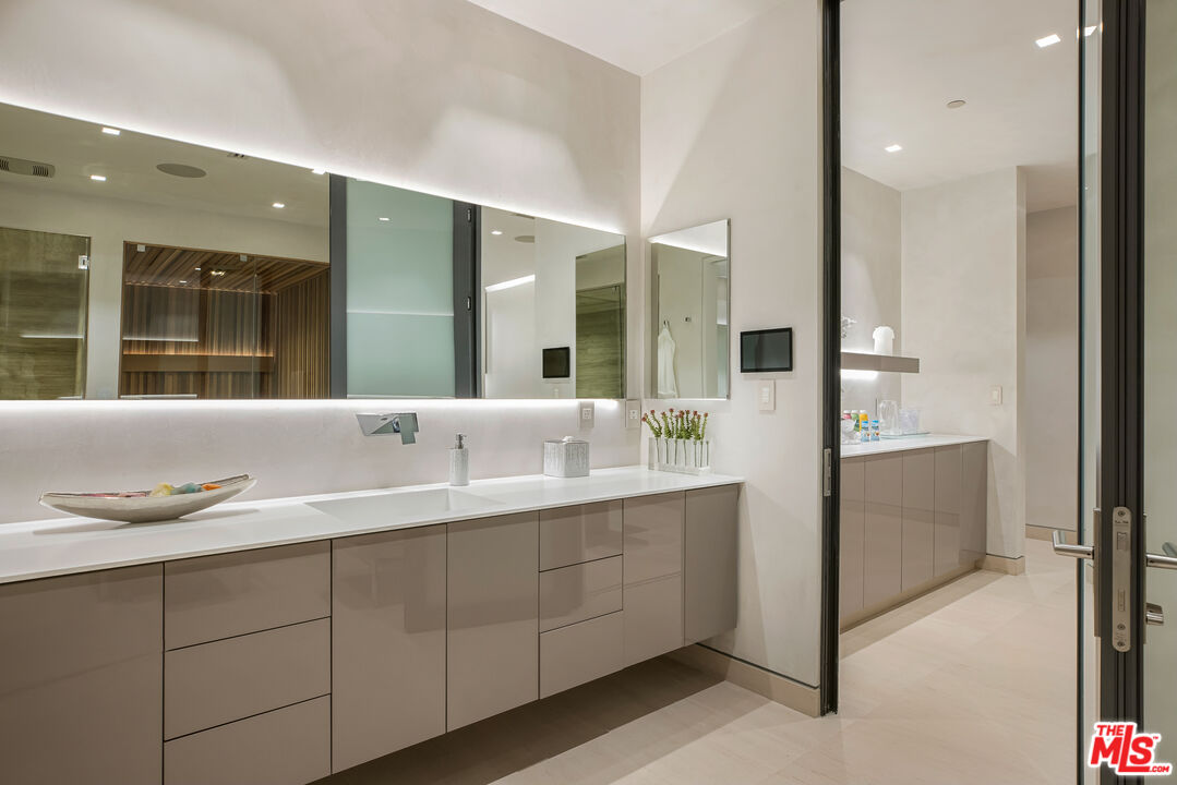 5046 Carbon Beach Terrace Malibu, CA 90265 - Photo 62 of 75 a bathroom with a granite countertop sink and a mirror