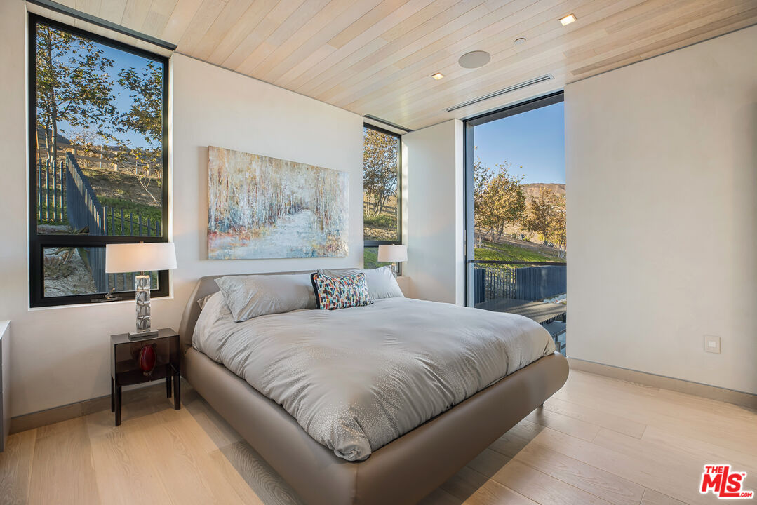 5046 Carbon Beach Terrace Malibu, CA 90265 - Photo 64 of 75 a bedroom with a large bed and a window