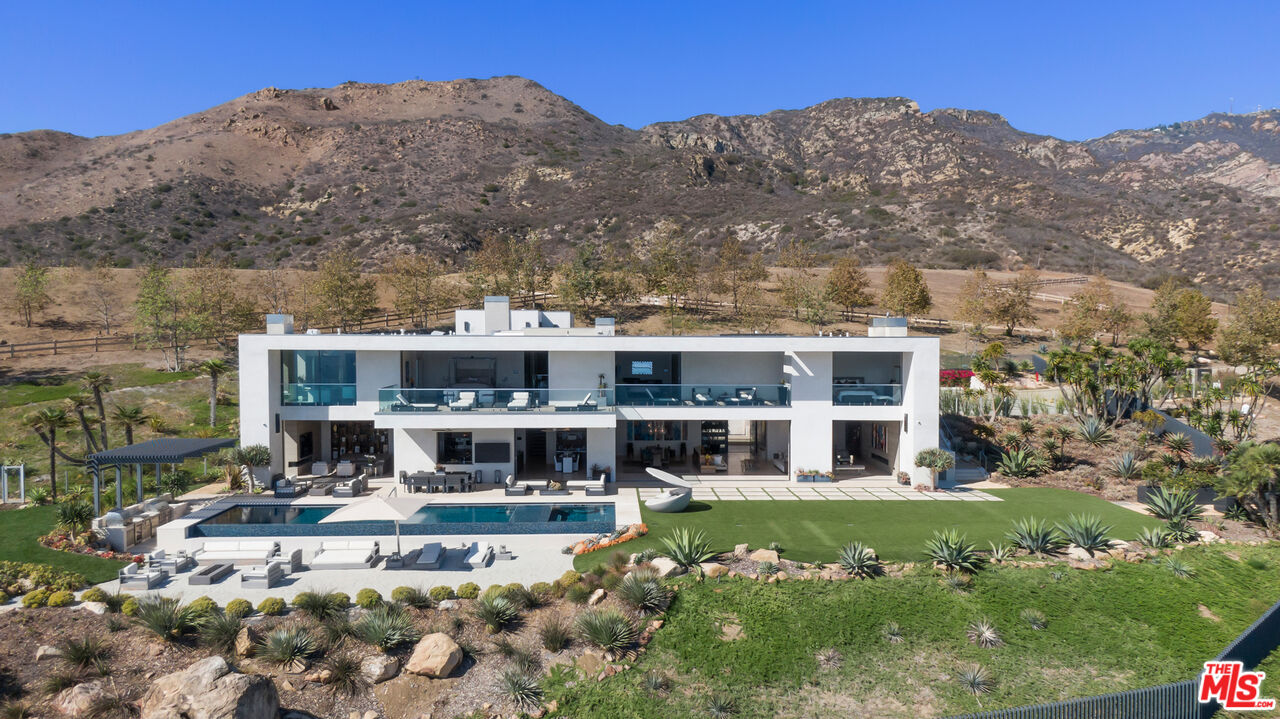5046 Carbon Beach Terrace Malibu, CA 90265 - Photo 71 of 75 a view of a big house with a big yard and large trees